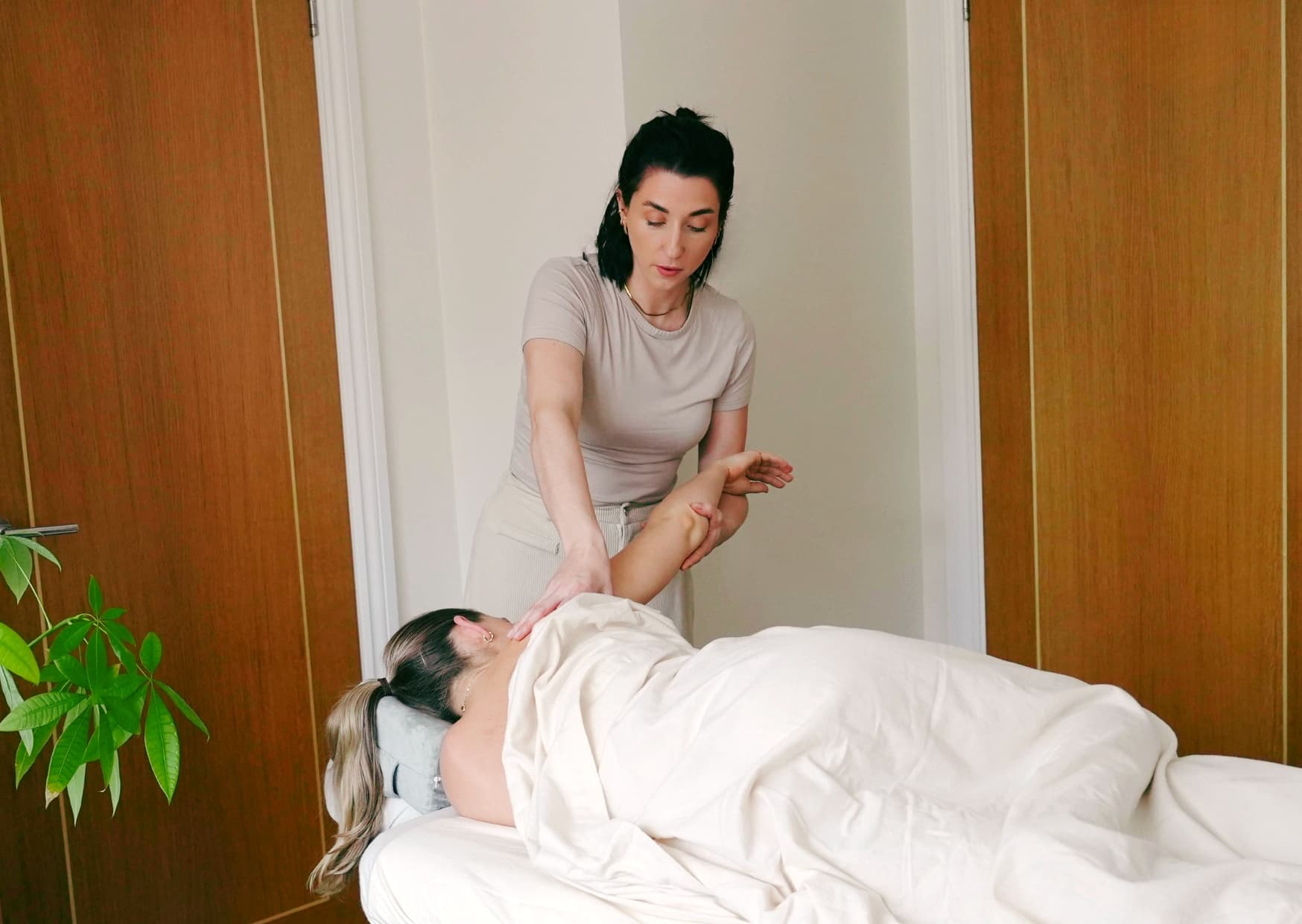 Rebecca working with a client on a treatment couch